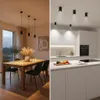 A split image showing a dining room with a table and chairs on the left, and a modern kitchen with cabinets and a countertop on the right. Produktbild-Vorschau