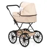 A classic-style doll's pram with a beige fabric body and black metal frame and wheels, set against a white background. Produktbild-Vorschau