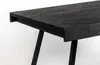 Close-up view of the corner of a black wooden table with black metal legs. Produktbild-Vorschau