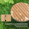 A circular wooden-looking shower head on grass, with a close-up inset showing the material and a water nozzle. Produktbild-Vorschau