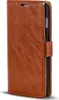 A brown leather wallet case for a smartphone, shown from a side-angle with the cover slightly ajar. Produktbild-Vorschau