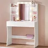 A white vanity table with a mirror and LED lights, stocked with makeup and accessories. Produktbild-Vorschau