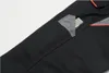 A close-up view of a black work pant pocket with a folding ruler inside. Produktbild-Vorschau