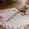 A close-up of a Christmas-themed pencil shaped like a candy cane, resting on a stack of stationery for writing letters to Santa. Anteprima dell’immagine prodotto