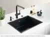 A black granite sink with a black faucet and accessories on a white countertop. Podgląd zdjęcia produktu
