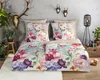 A beautifully made bed with a floral duvet cover and pillows, decorated with natural elements like deer antlers and plants. Produktbild-Vorschau
