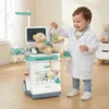 A young child dressed as a doctor plays with a medical trolley toy. Anteprima dell’immagine prodotto