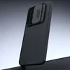 A black phone case with a textured surface and a sliding camera cover is shown at an angle against a gradient background. Náhľad obrázku produktu