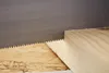 A close-up shot of a saw blade cutting into a piece of wood. Náhľad obrázku produktu