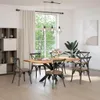 A dining room with a wooden table and chairs, a large window with greenery outside, and a bookshelf. Podgląd zdjęcia produktu