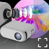 A mini projector is shown with its internal lens components exploded outwards, projecting an image of a colorful flower. The background is dark with abstract circular lines. Voir les images du produit