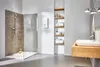 A modern bathroom with a shower and a sink area, showcasing a water heater. Produktbild-Vorschau