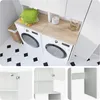A laundry room with a washing machine and dryer, cabinets, and a tiled floor. Anteprima dell’immagine prodotto