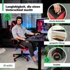 A man is sitting in a gaming chair at a desk with a computer. Náhled obrázku produktu