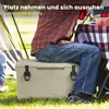 A person is sitting on a cooler box in a grassy outdoor setting, with a tent and picnic table in the background. Náhľad obrázku produktu