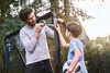 A father and son are repairing a soccer goal in a backyard. Produktbild-Vorschau