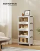 A multi-tiered storage unit with transparent doors is shown in a room setting, next to a sofa and a table. Produktbild-Vorschau