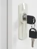 A close-up of a lock mechanism with two keys. Produktbild-Vorschau