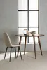 A dining table and chair set in a room with a large window. Produktbild-Vorschau