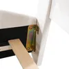 A close-up view of the corner of a white upholstered bed frame, showing a metal bracket and a wooden slat. Produktbild-Vorschau
