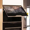 A smart TV integrated into a kitchen cabinet, angled upwards. Produktbild-Vorschau