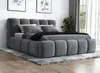 A grey upholstered bed with a headboard and frame, shown with pillows and a blanket, placed on a rug in a room. Produktbild-Vorschau