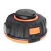 A close-up studio shot of a black and orange trimmer head. Podgląd zdjęcia produktu