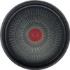 The bottom of a black frying pan with a red circular logo and radiating white lines. Podgląd zdjęcia produktu