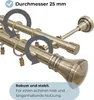 Close-up view of two curtain rods with decorative finials, showing rings and clips. Produktbild-Vorschau