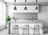 A modern kitchen with a concrete island and pendant lights. Podgląd zdjęcia produktu