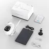 A white security camera, solar panel, and accessories are laid out on a white surface, with a product box in the background. Produktbild-Vorschau