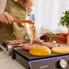 A person is grilling bacon and burgers on an electric grill. Voir les images du produit