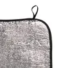 A close-up view of a silver insulated cushion with a black edge and a black loop at the top. Produktbild-Vorschau