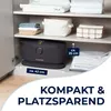 A closet shelf with a product and folded towels. Produktbild-Vorschau