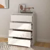 A white chest of drawers with four drawers, some of which are open, is shown in a room with a patterned rug and a wall with artwork. Voir les images du produit