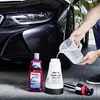 A person is pouring liquid from a measuring jug into a foam sprayer next to a car. Produktbild-Vorschau