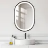 A bathroom vanity with a sink, faucet, and a lit oval mirror. Produktbild-Vorschau