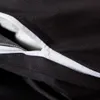 A close-up view of a black duvet cover with a partially opened zipper, revealing white filling. Produktbild-Vorschau