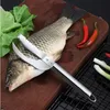 A fish scaler tool is placed on a fish on a wooden cutting board, with chili peppers and green onions in the background. Náhled obrázku produktu