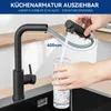 A person is using a black kitchen faucet with an extendable hose to fill a glass with water. Produktbild-Vorschau