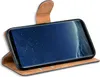 A smartphone in a brown flip case, shown from a side angle. Náhľad obrázku produktu