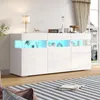 A modern white sideboard with LED lighting is displayed in a living room setting, with a striped rug in the foreground and curtains in the background. Produktbild-Vorschau