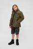 A young person modeling an outdoor jacket and shorts. Produktbild-Vorschau