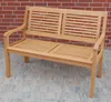 A wooden garden bench is shown in front of a brick wall and on a paved patio. Produktbild-Vorschau