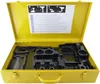 An open yellow metal case with a black plastic insert designed to hold tools. The lid of the case has an instructional diagram and text. Podgląd zdjęcia produktu