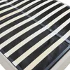 A close-up view of the wooden slats and metal frame of a bed base. Produktbild-Vorschau