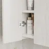 A close-up view of an open bathroom cabinet, showing cosmetic products on shelves and a hinge. Náhled obrázku produktu