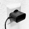 A black power adapter is plugged into a white wall socket. Anteprima dell’immagine prodotto