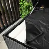 Close-up view of the inside of a black wicker storage box, showing a white cushion and a black waterproof liner. Náhľad obrázku produktu
