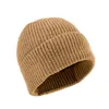A close-up studio shot of a brown knitted beanie.